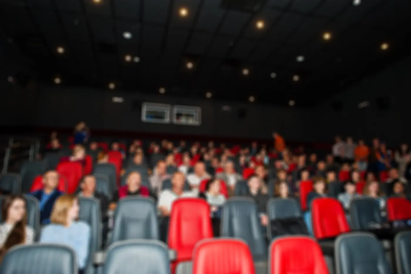 A seated audience in a tiered auditorium
