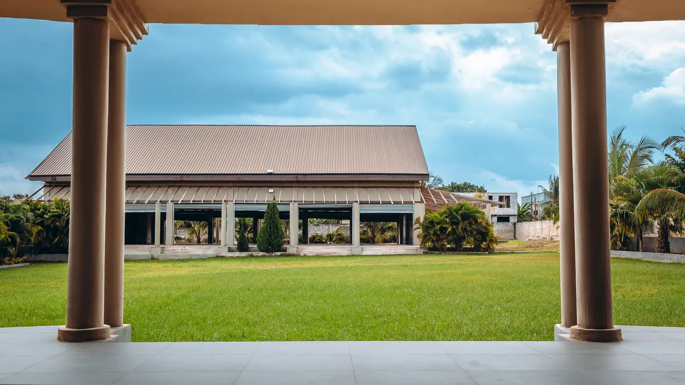 The auditorium framed between two terrace columns, the lawn running between them