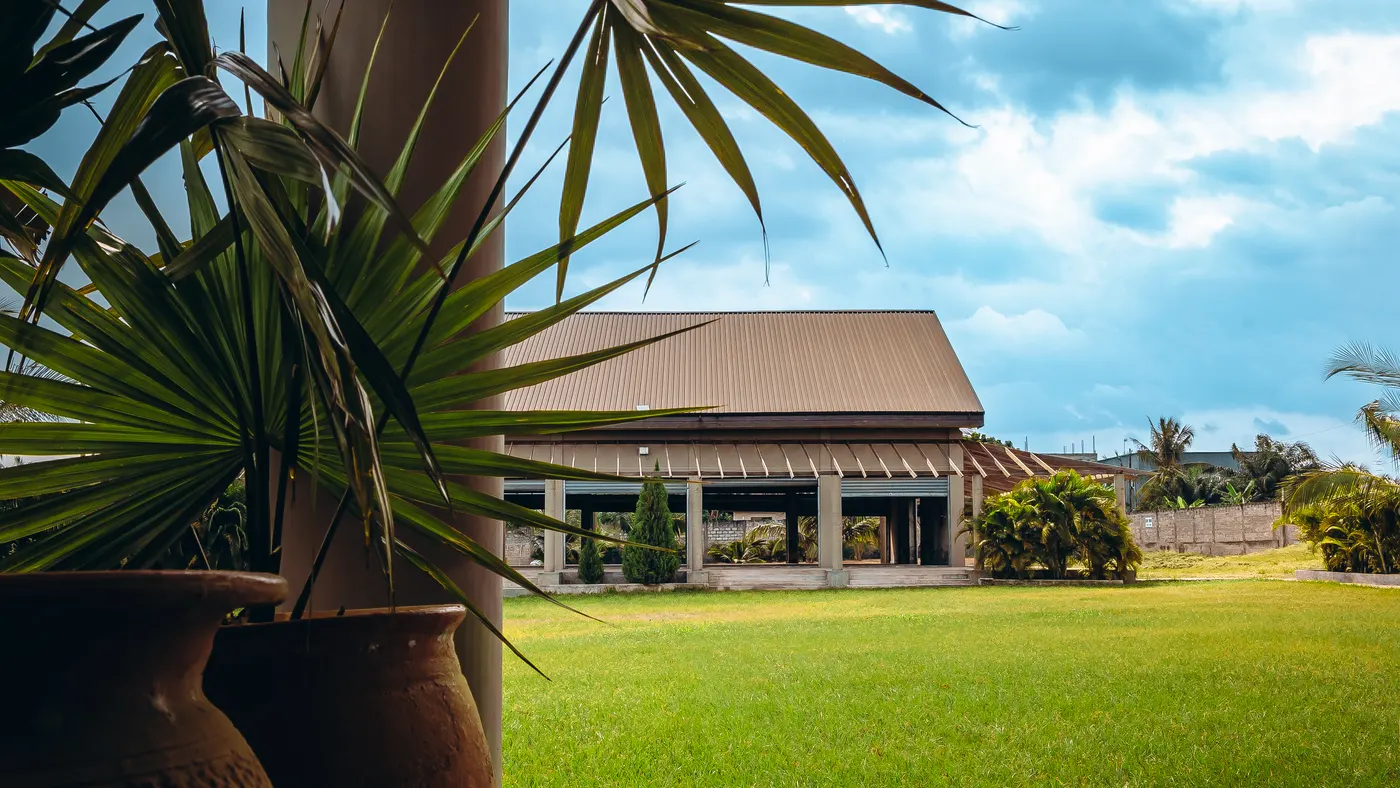 The auditorium across the grass, with planted urns in the foreground
