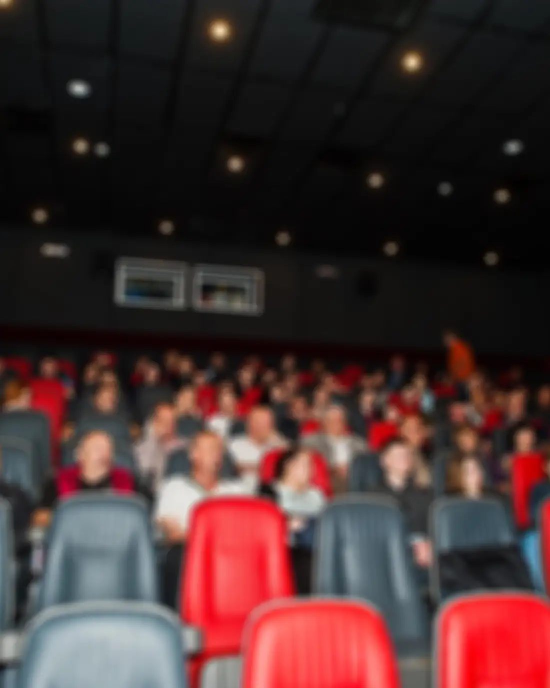 A seated audience in a tiered auditorium