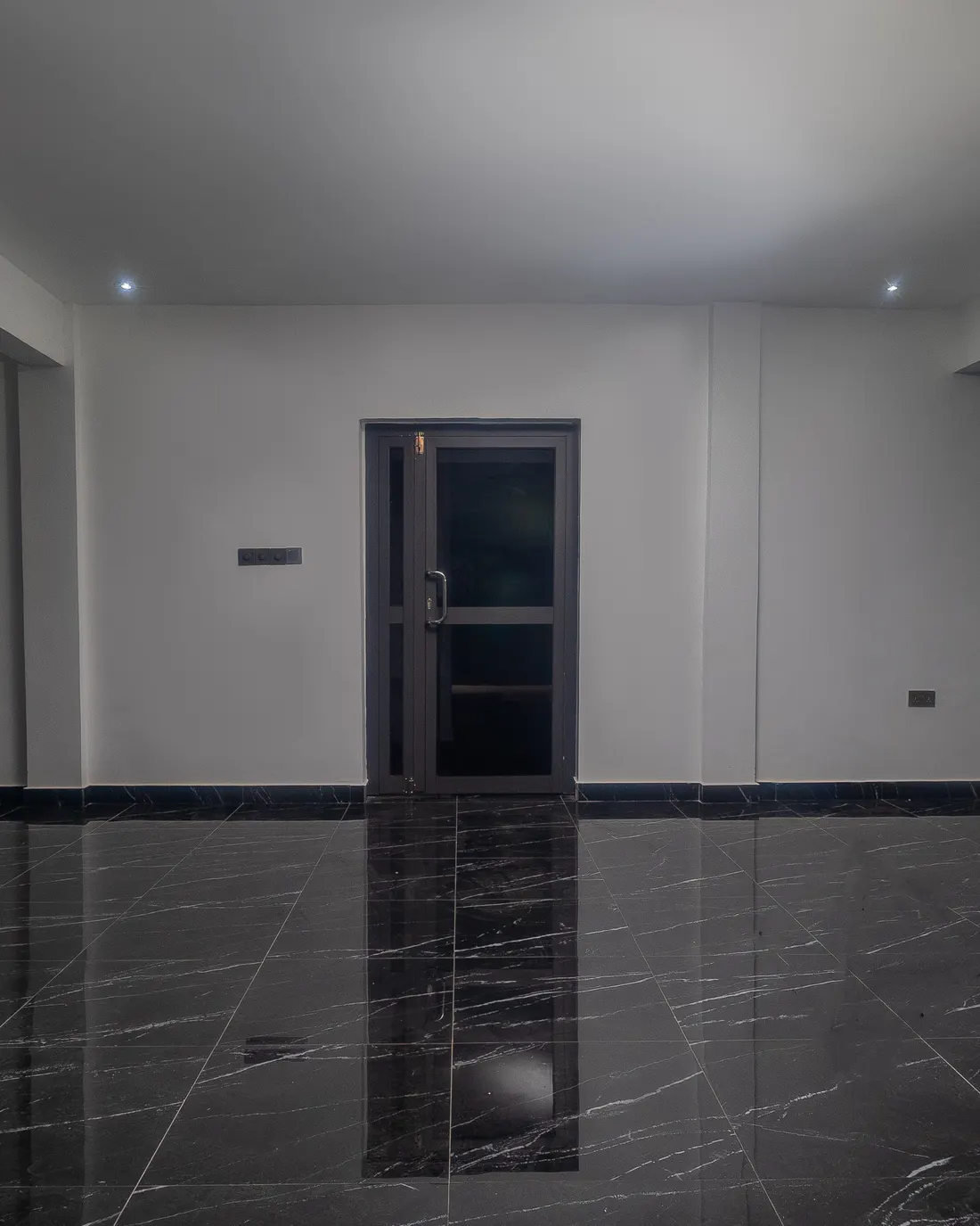 The Executive Hall, its doorway reflected in a polished dark floor