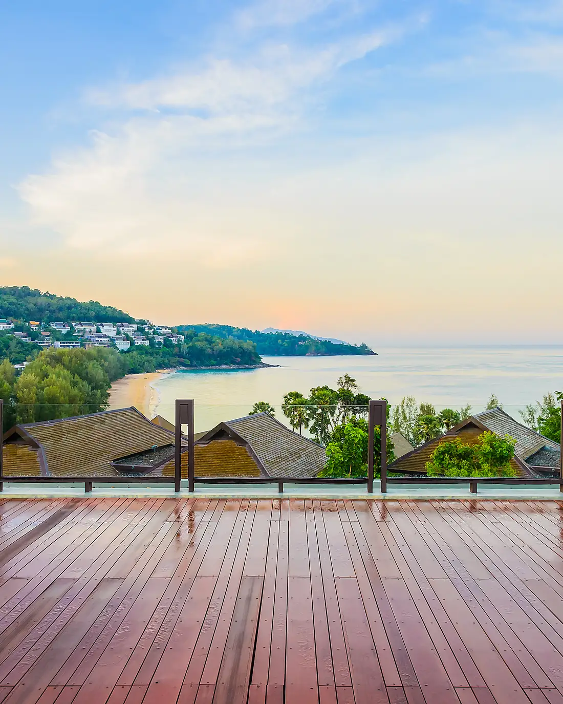 An open-air timber terrace looking out over trees and water