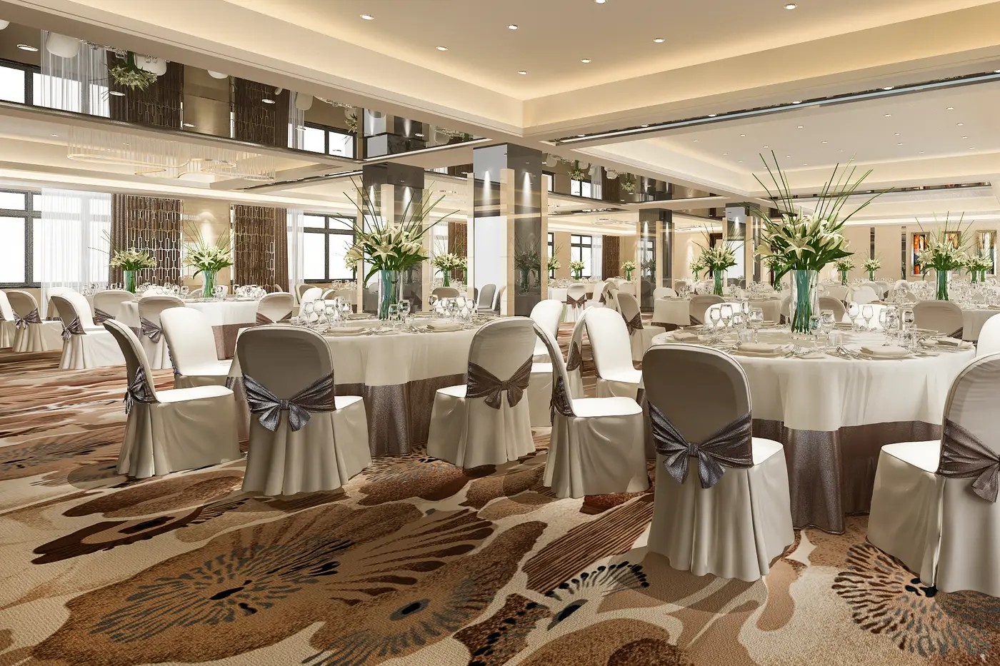 Round tables laid with place settings and flowers for a banquet