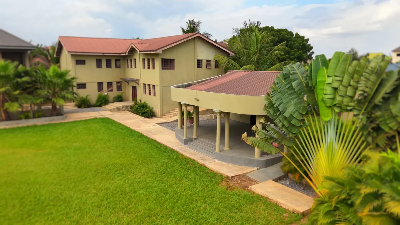 The paved walk between the buildings and the lawn, from above