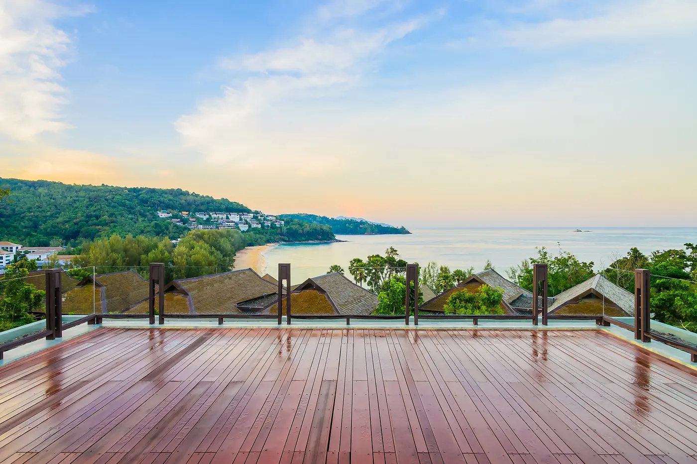 An open-air timber terrace looking out over trees and water