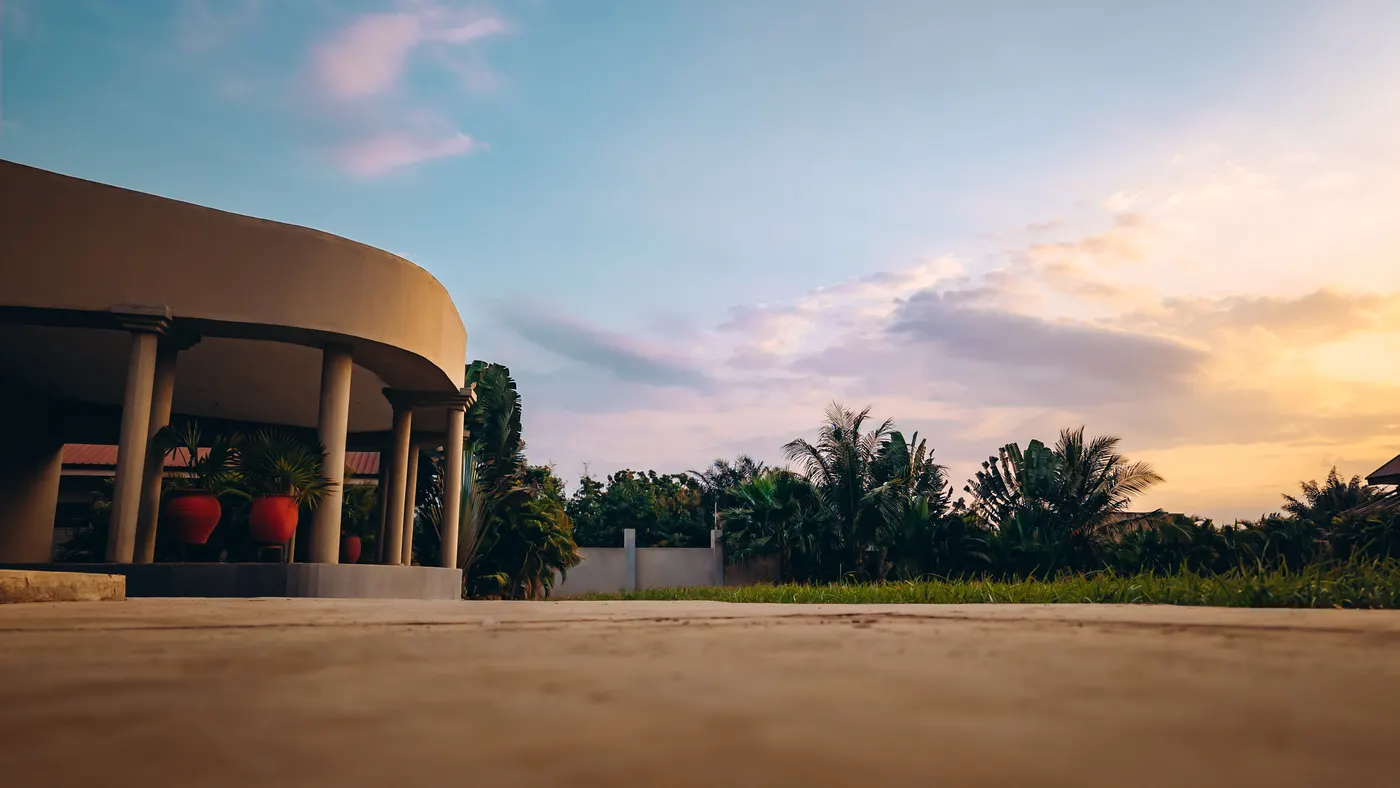 The terrace colonnade in the evening, the grounds beyond it